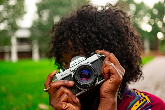 Woman holding camera taking pictures